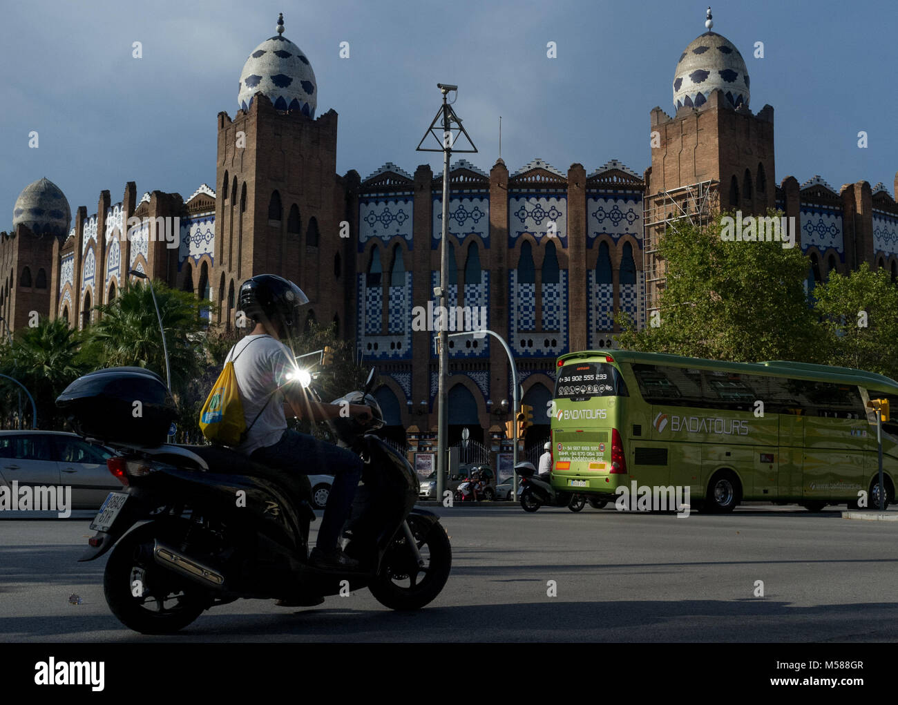 September 8, 2014 Barcelona, Spain. A young man rides a scooter next to the La Monumental arena in Barcelona Stock Photo