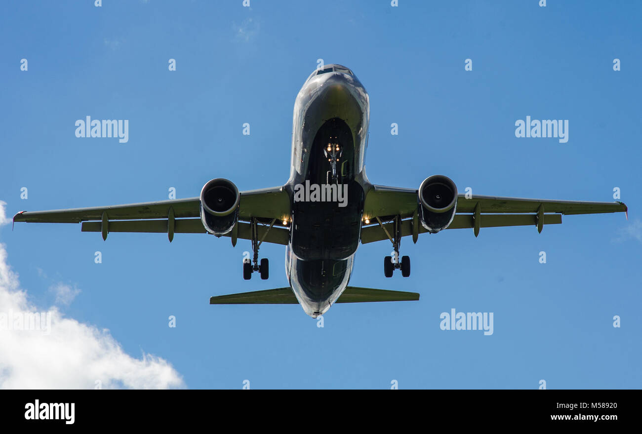 The plane on a background of blue sky and white clouds Stock Photo - Alamy