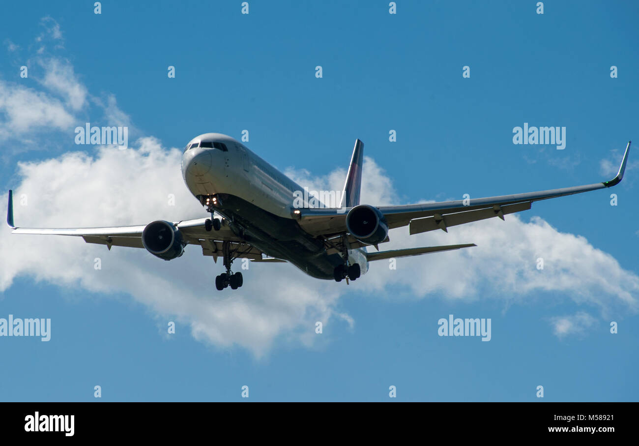 The plane on a background of blue sky and white clouds Stock Photo - Alamy