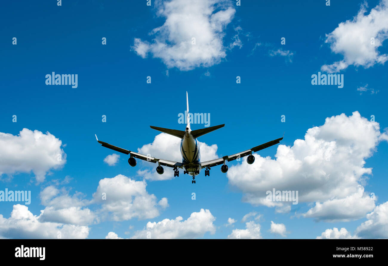 The plane on a background of blue sky and white clouds Stock Photo - Alamy
