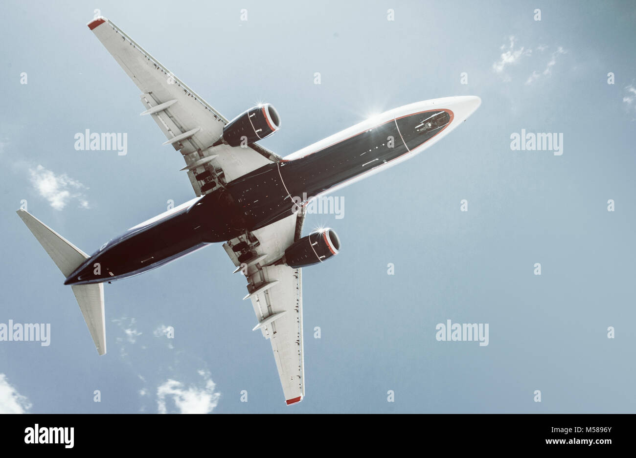 The plane on a background of blue sky and white clouds Stock Photo - Alamy