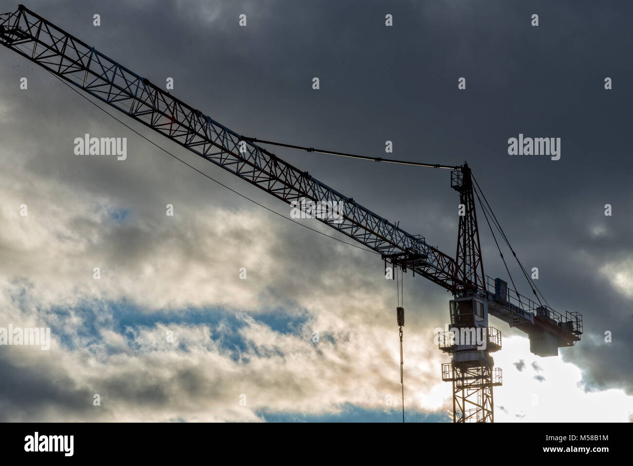 A construction crane with many clouds in the background Stock Photo - Alamy