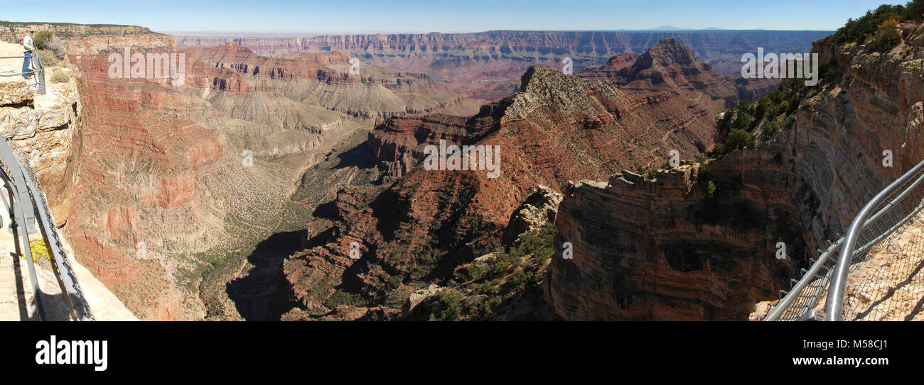 Grand Canyon North Rim From Angels Window . (9000 x 3105)  From the North Rim Visitor Center, Cape Royal is a 23 mile/ 37 km drive that takes 45 minutes to an hour each way.  In this photo, Freya Castle and Vishnu Temple are shown as seen from the narrow walkway above Angels Window, at the eastern end of Cape Royal on the North Rim of Grand Canyon National Park. Cape Royal provides a panorama up, down, and across the canyon. With seemingly unlimited vistas to the east and west, it is popular for both sunrise and sunset. The sweeping turn of the Colorado River at Unkar Delta can be framed throu Stock Photo