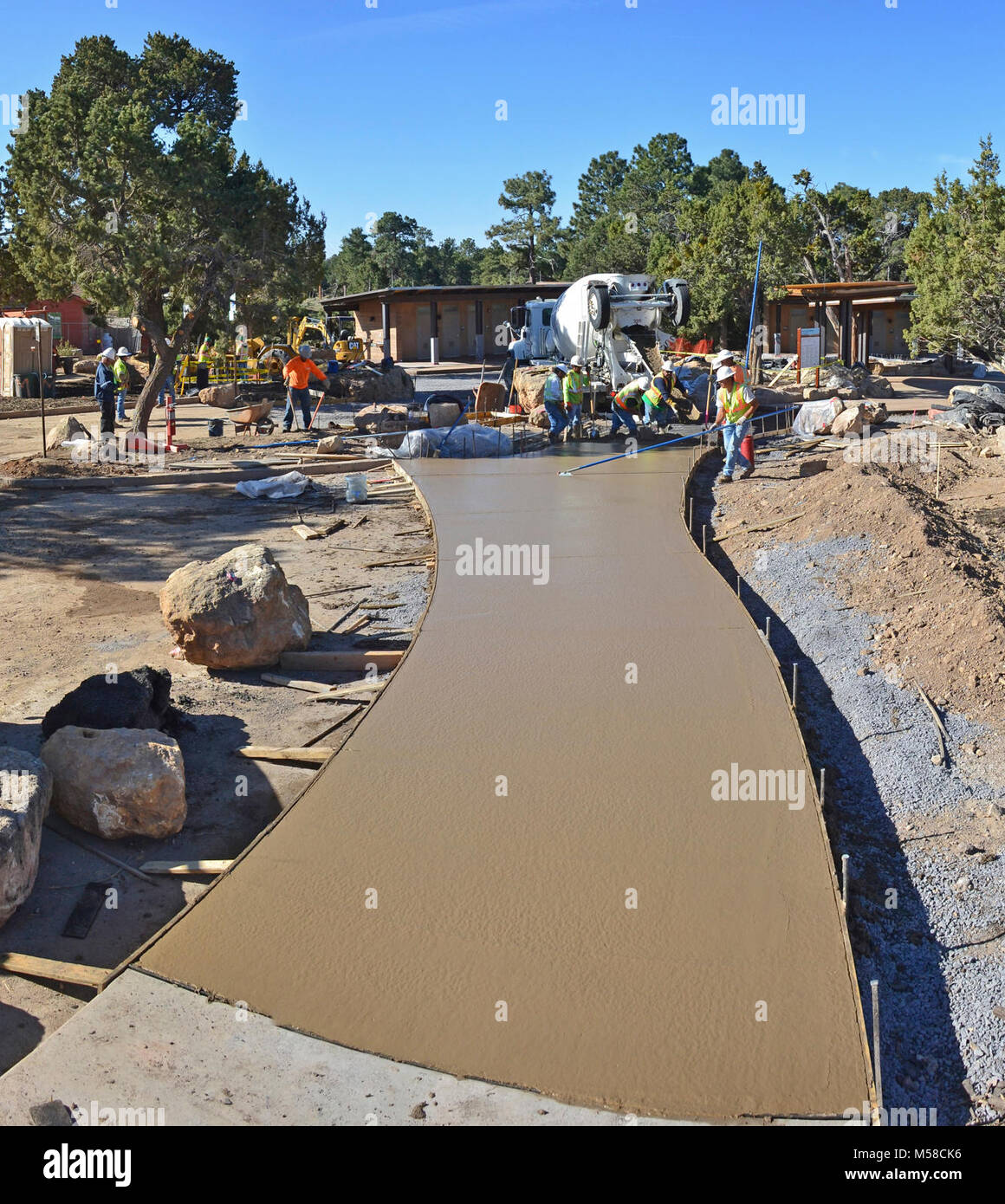 Grand Canyon NP Bright Angel Trailhead Project Concrete Walkway Paving. April, 24, 2013. With landscape boulders and stonework set in place, workers are now completing the pavement . This includes concrete portions of the trailhead plaza and the remaining footpaths. The overall project is on schedule and should completed by mid May, 2013. NPS Stock Photo