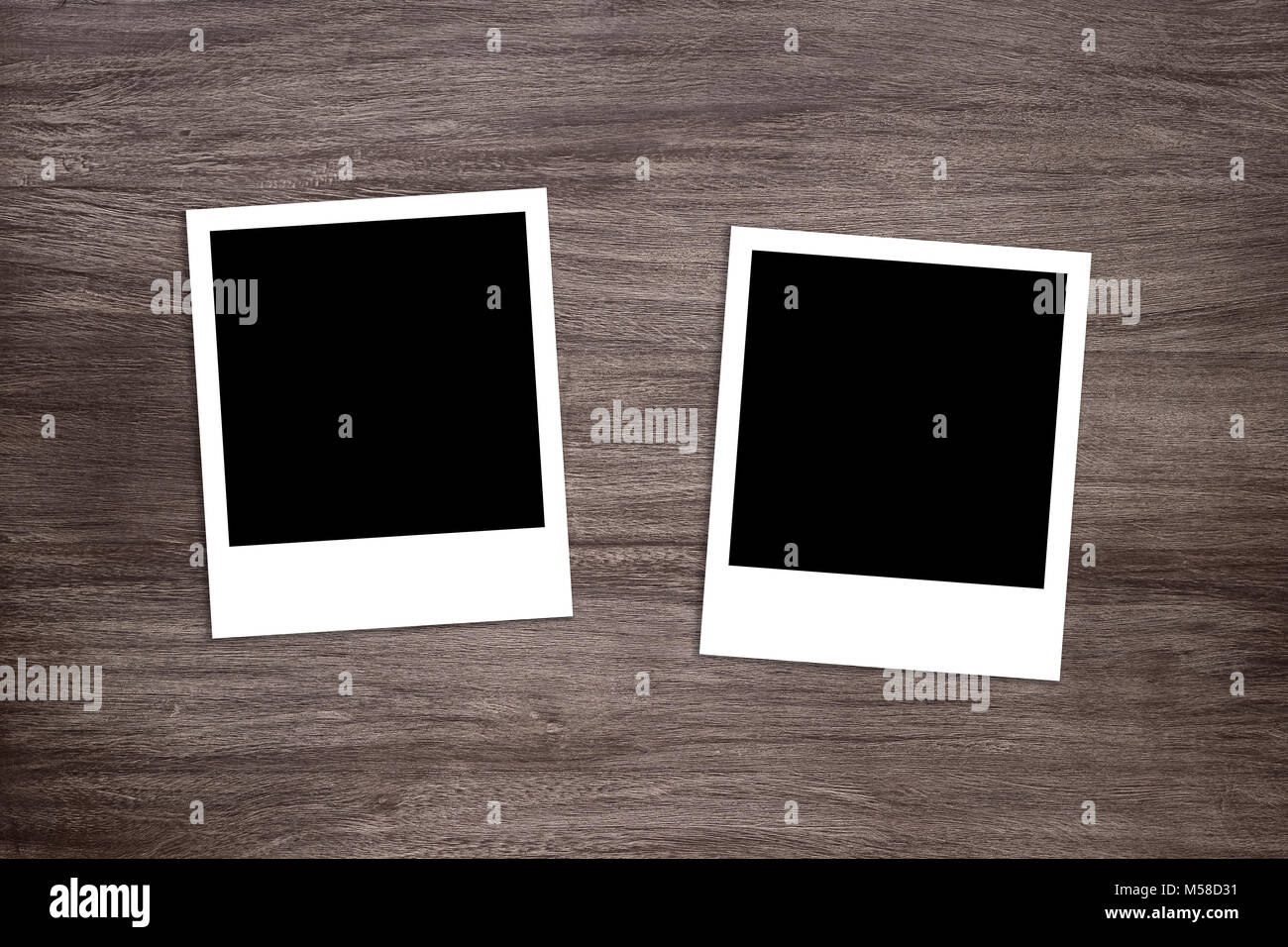 two blackened instant photo print templates on wooden background Stock Photo