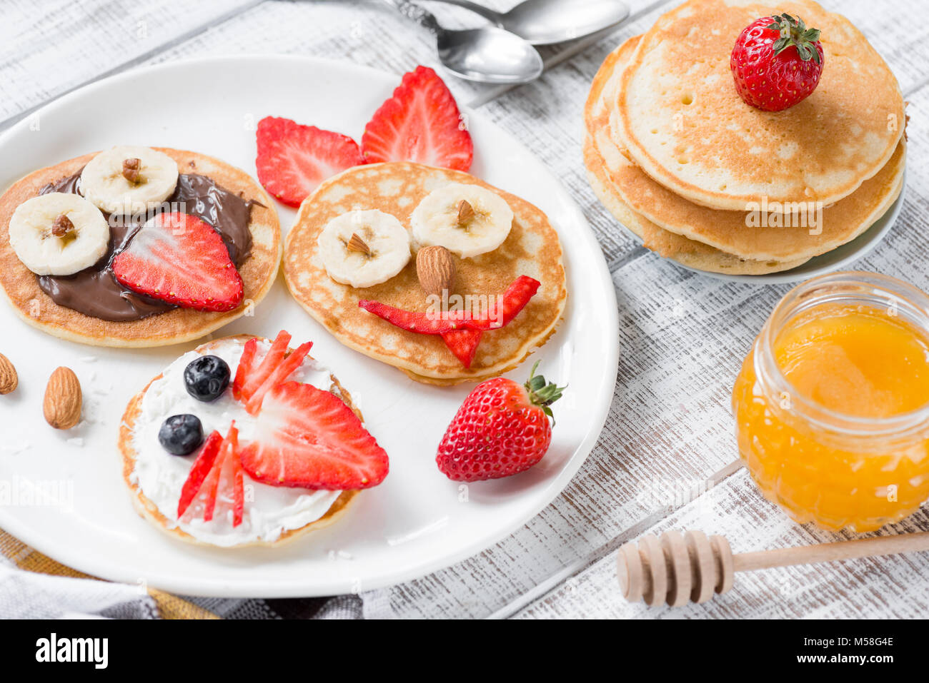 Colorful and funny breakfast for kids. Animal shaped pancakes on white plate. Creative food art, healthy breakfast for children concept Stock Photo
