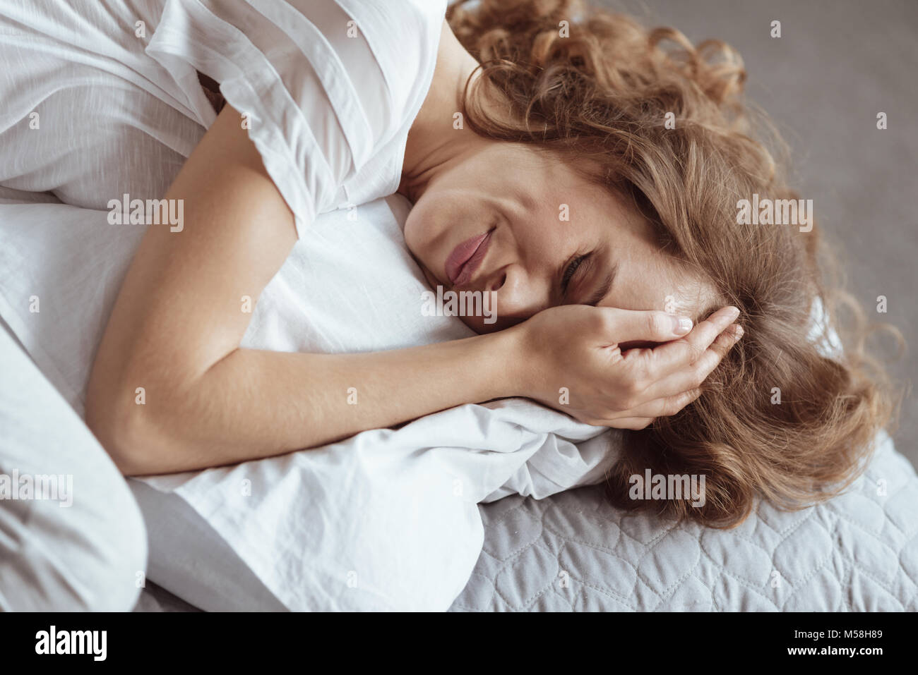 Emotionally exhausted woman crying on pillow Stock Photo Alamy