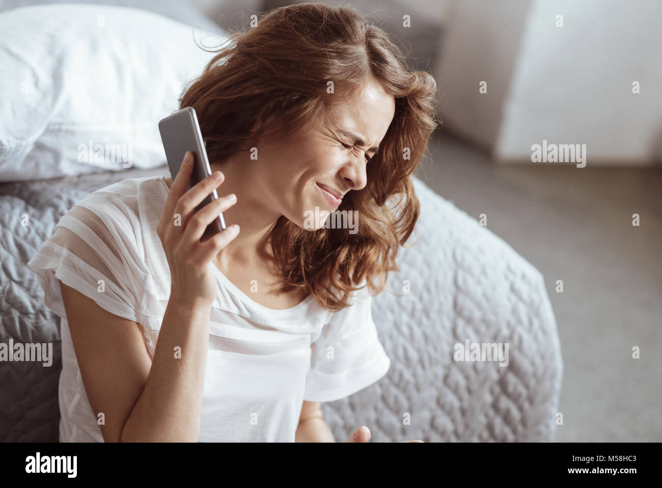 Irritated woman refusing to listen her partner on phone Stock Photo