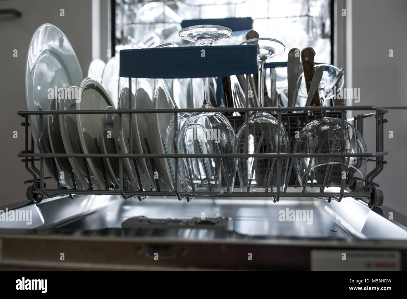 Open dishwasher with clean glass and dishes selective focus Clean