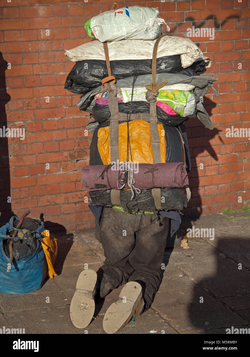 A homeless man with all his possessions in a great rucksack in Brighton Stock Photo