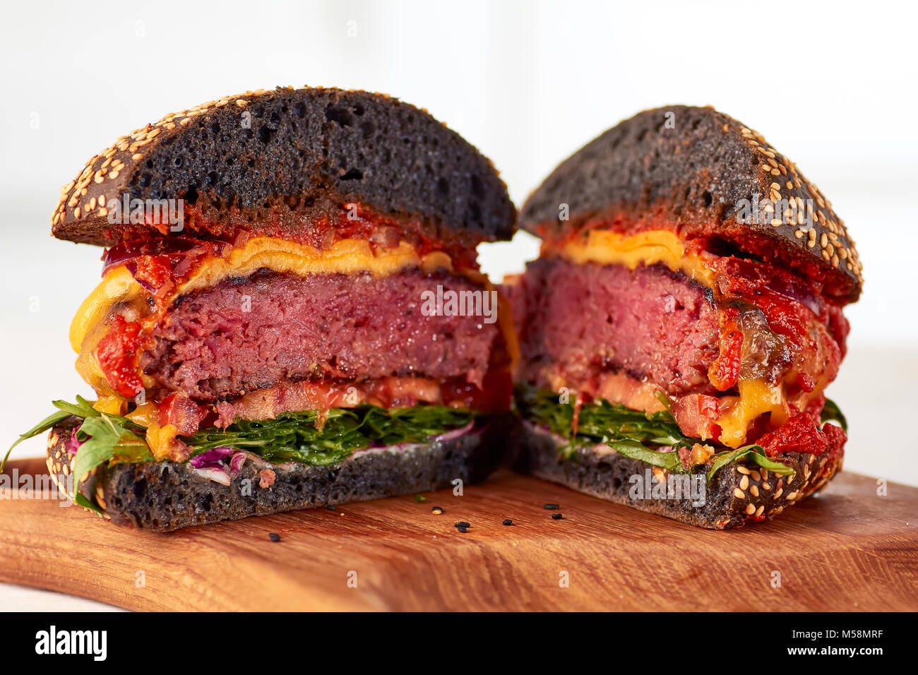 Sliced juicy cheeseburger Stock Photo