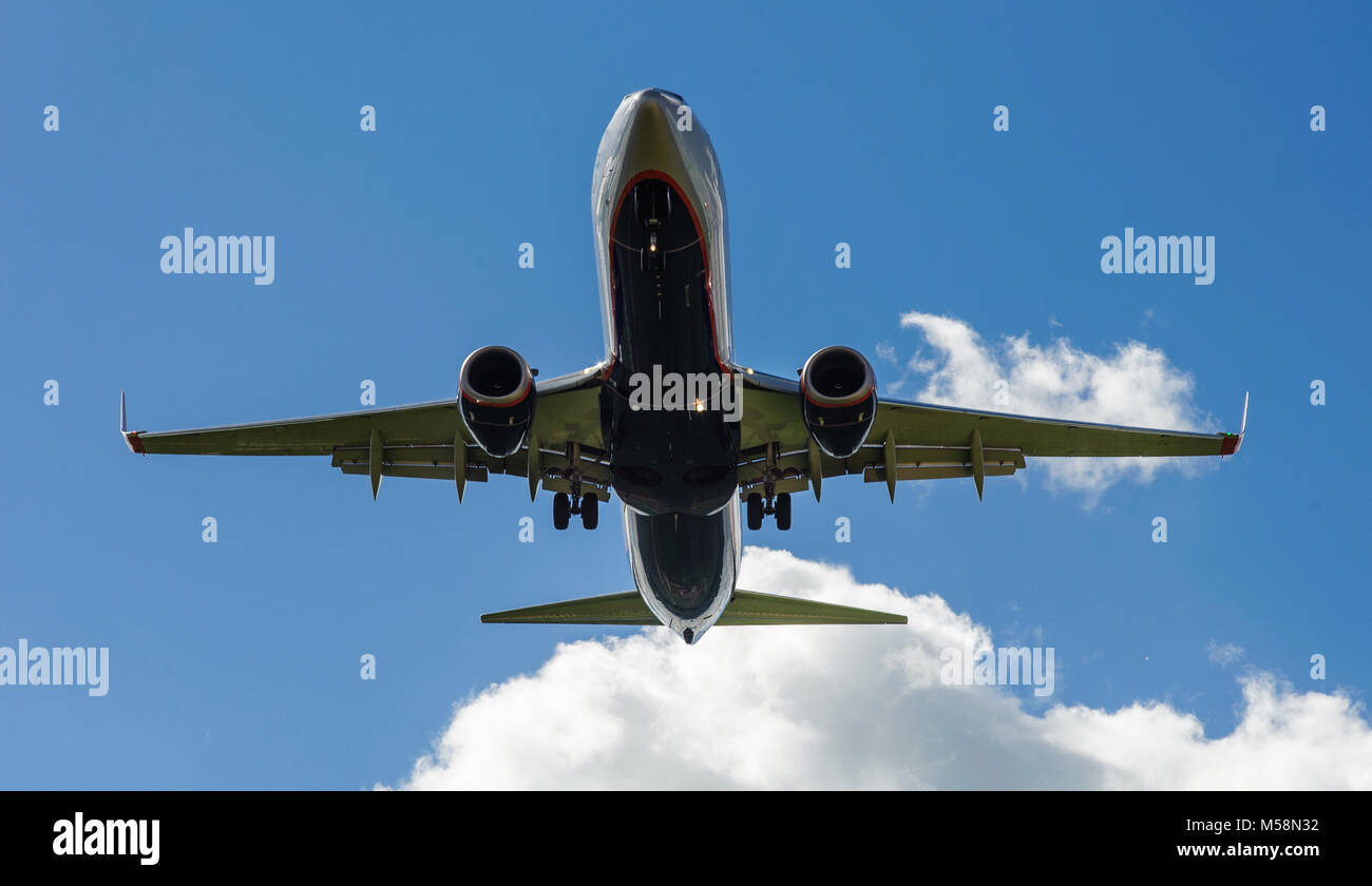 The plane on a background of blue sky and white clouds Stock Photo - Alamy
