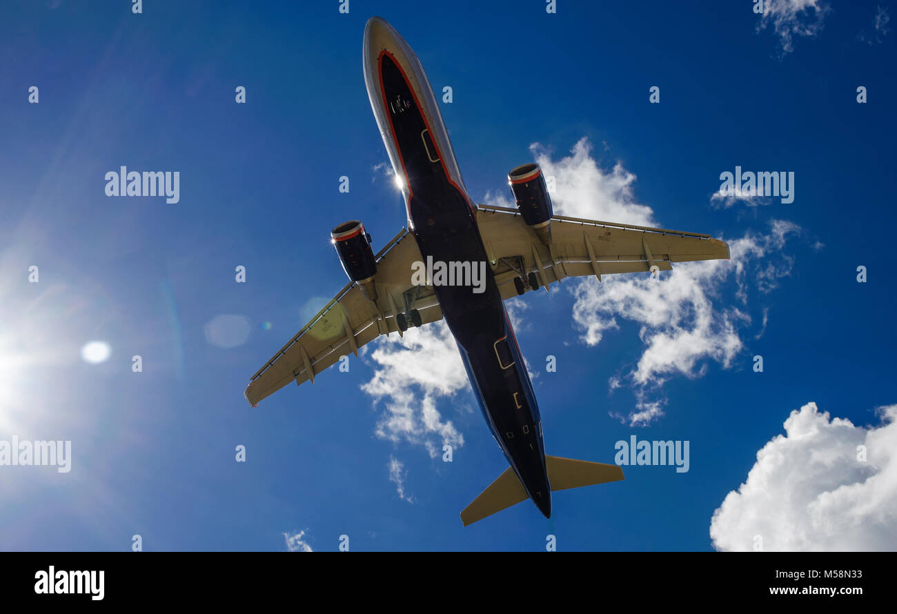 The plane on a background of blue sky and white clouds Stock Photo - Alamy