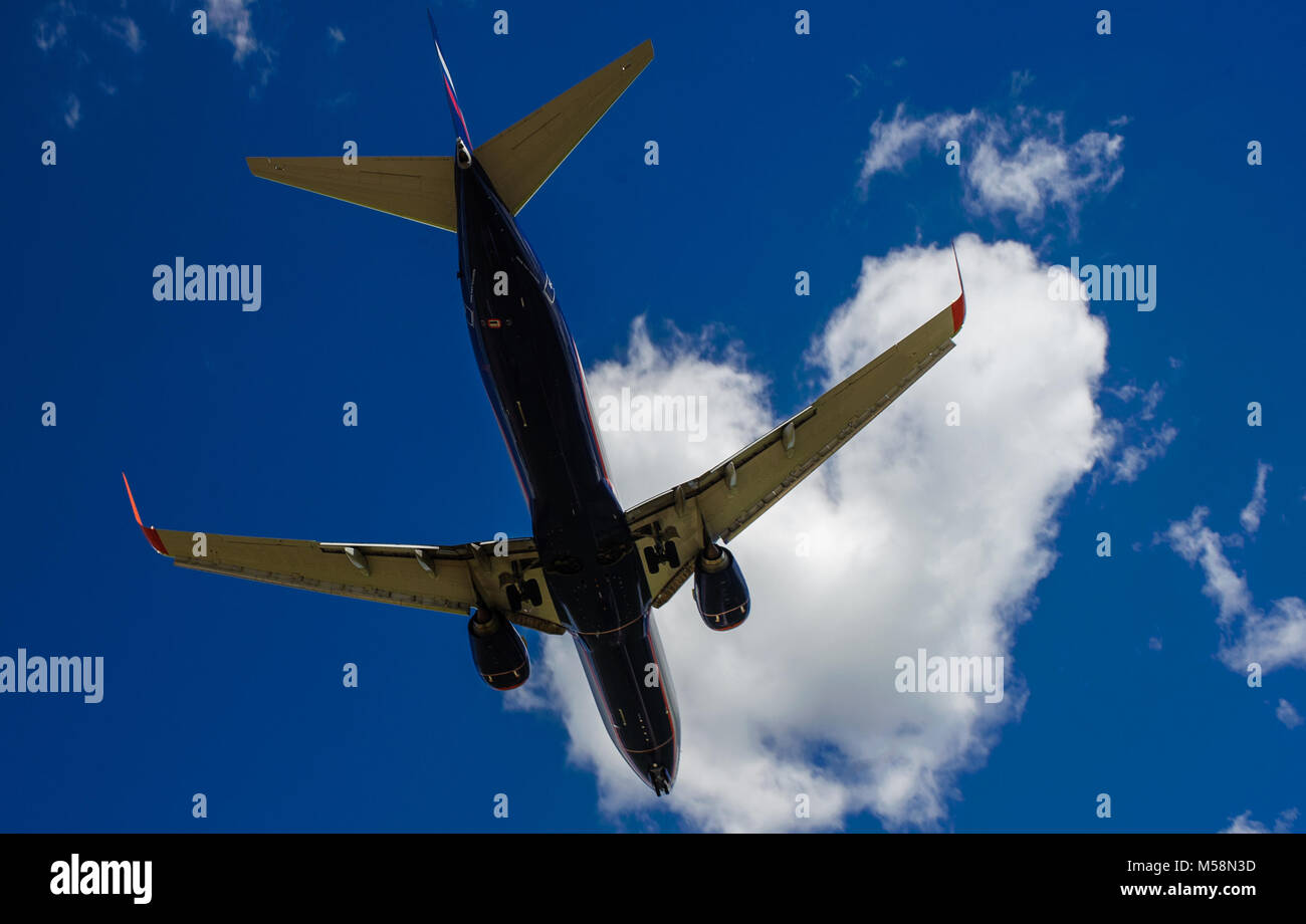 The plane on a background of blue sky and white clouds Stock Photo - Alamy