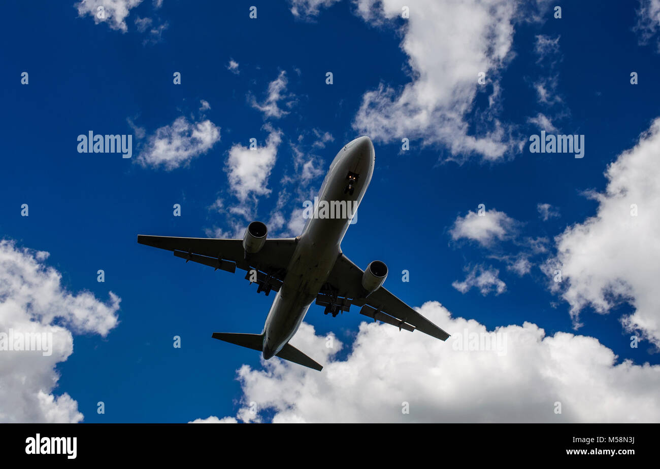 The plane on a background of blue sky and white clouds Stock Photo - Alamy