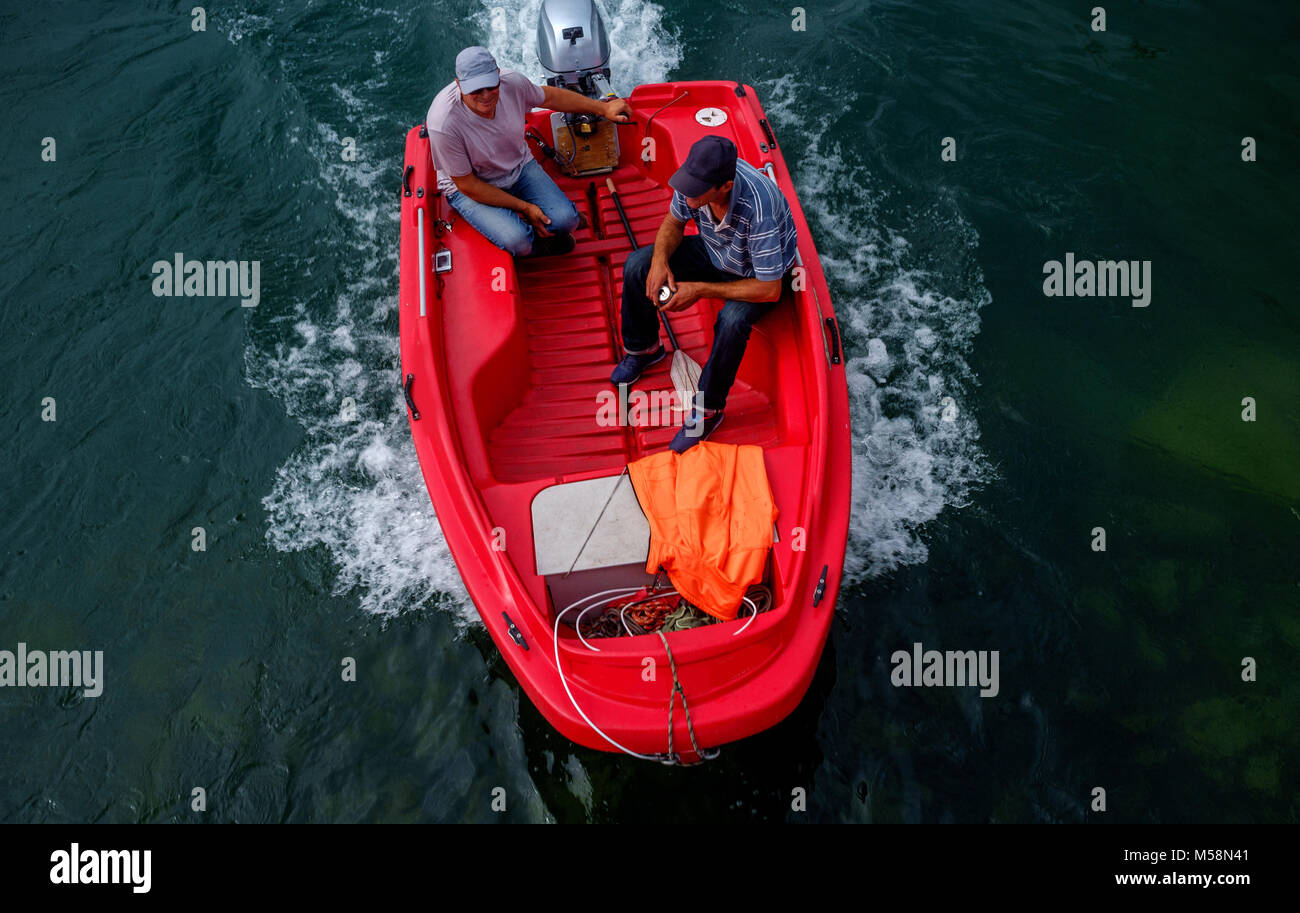 Two men fishing from inflatable boat on river Stock Photo by ©belchonock  170935864