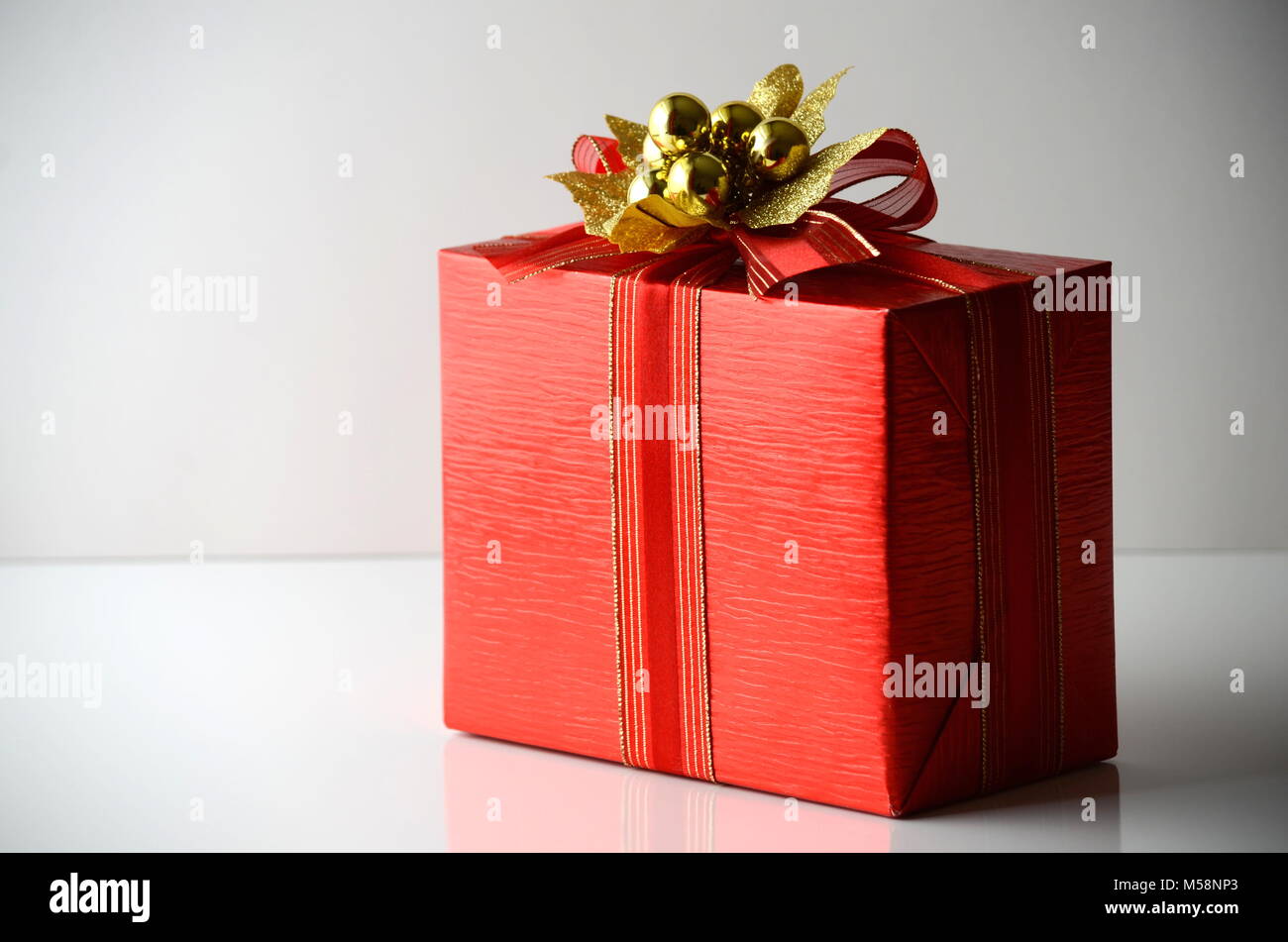 Gift box with gold coloured wrapping paper and a black ribbon and bow Stock  Photo - Alamy