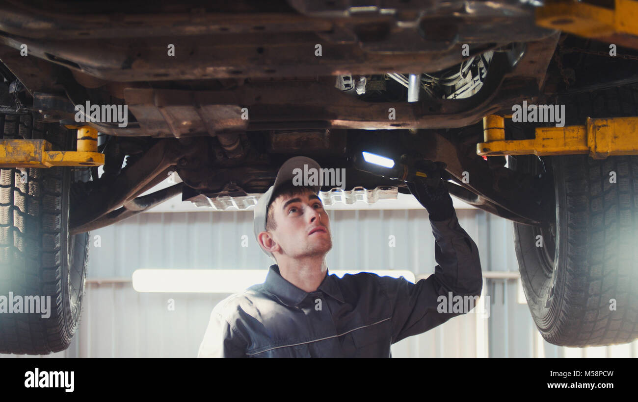 Car service a mechanic checks the suspension of SUV Stock Photo Alamy