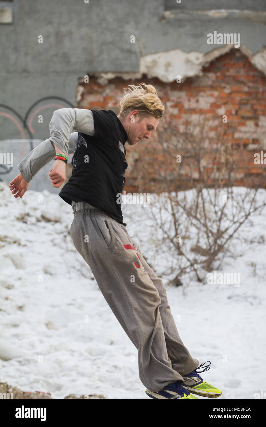 Parkour jumping in winter snow park freerun training Stock Photo Alamy