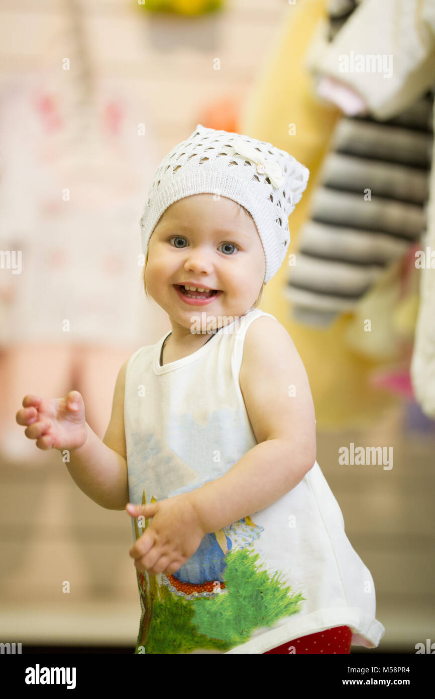The little baby girl dancing in clothes store Stock Photo Alamy
