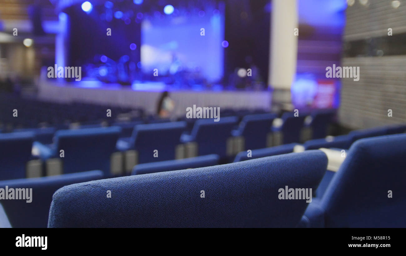 Blue chairs in a concert hall, blurred Stock Photo Alamy