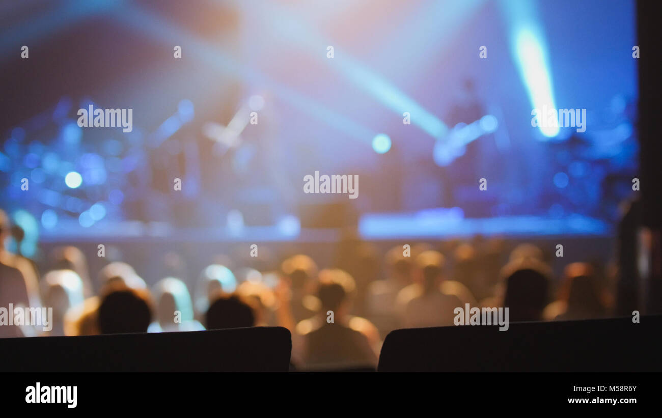 Concert background - silhouette of people dancing at the concert Stock