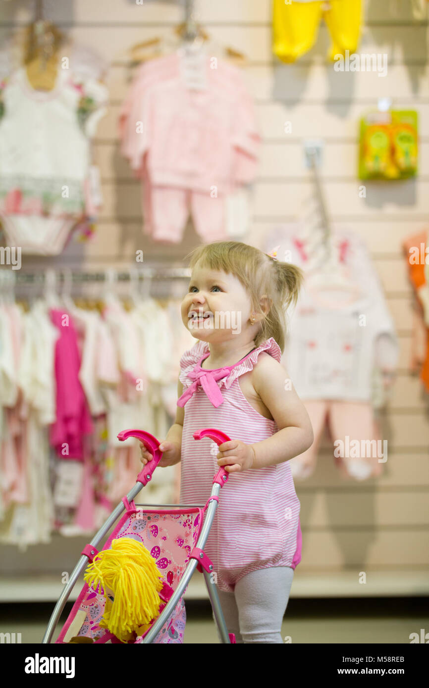 Happy little girl playing with her toy Stock Photo - Alamy