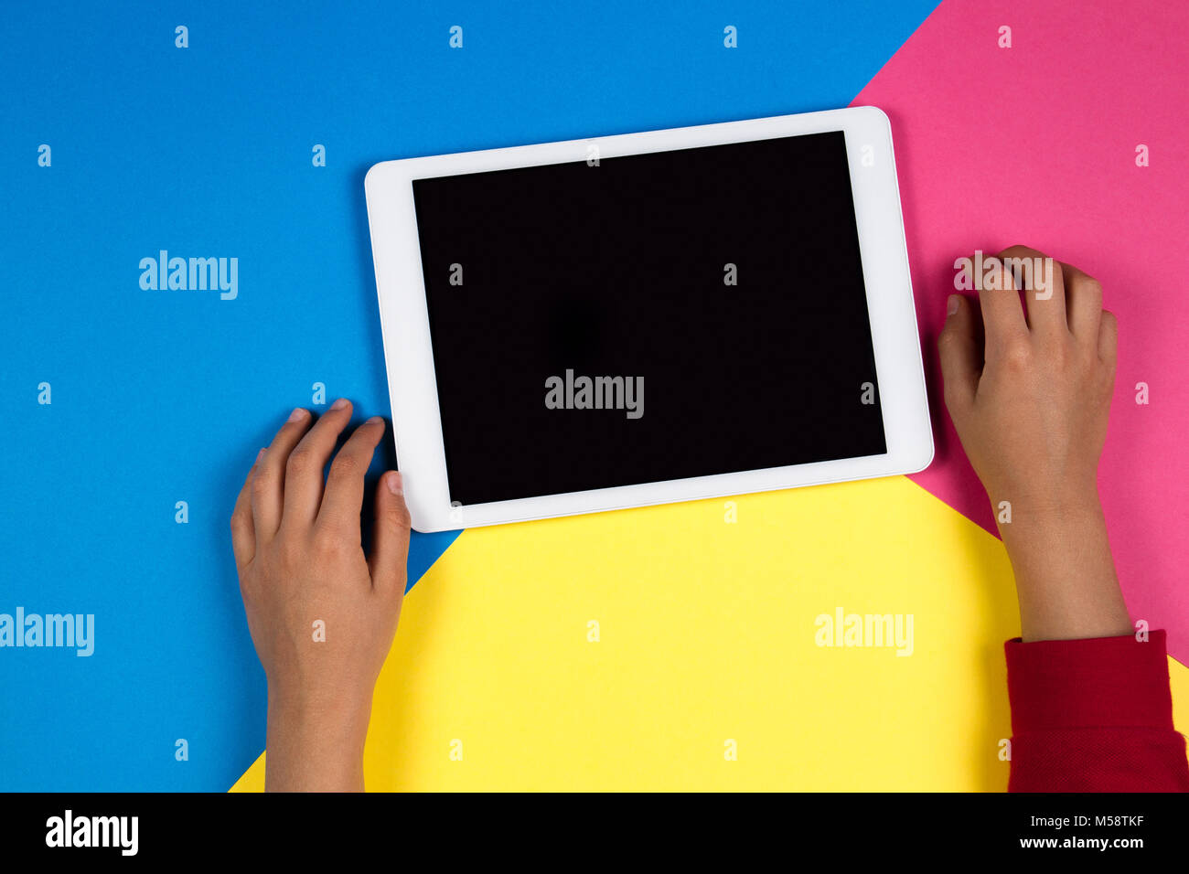 Kid Computer Hand Kid hands with tablet computer on colorful background Stock Photo - Alamy