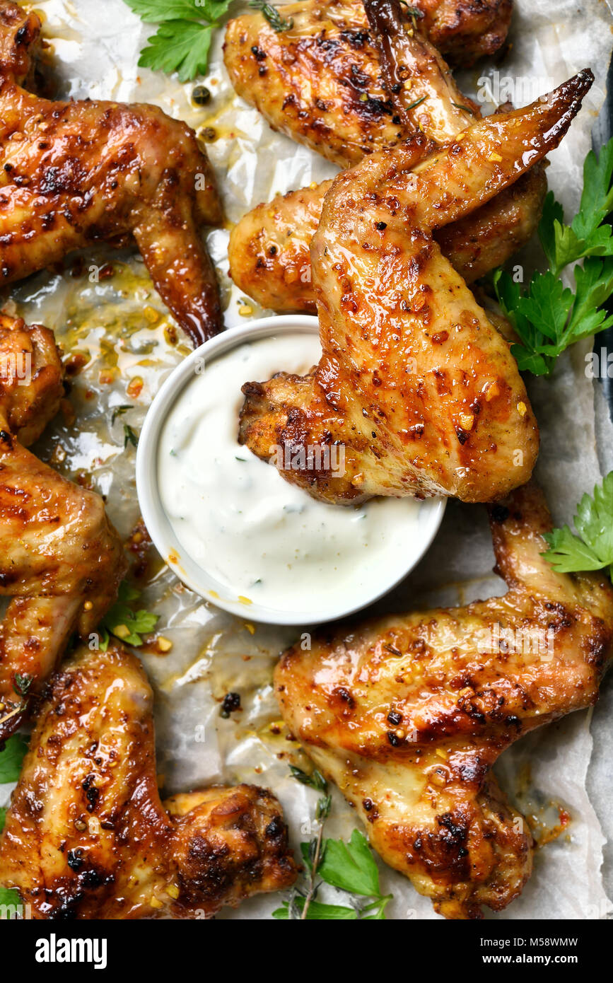 Fried chicken wings with white sauce, close up view. Top view, flat lay Stock Photo