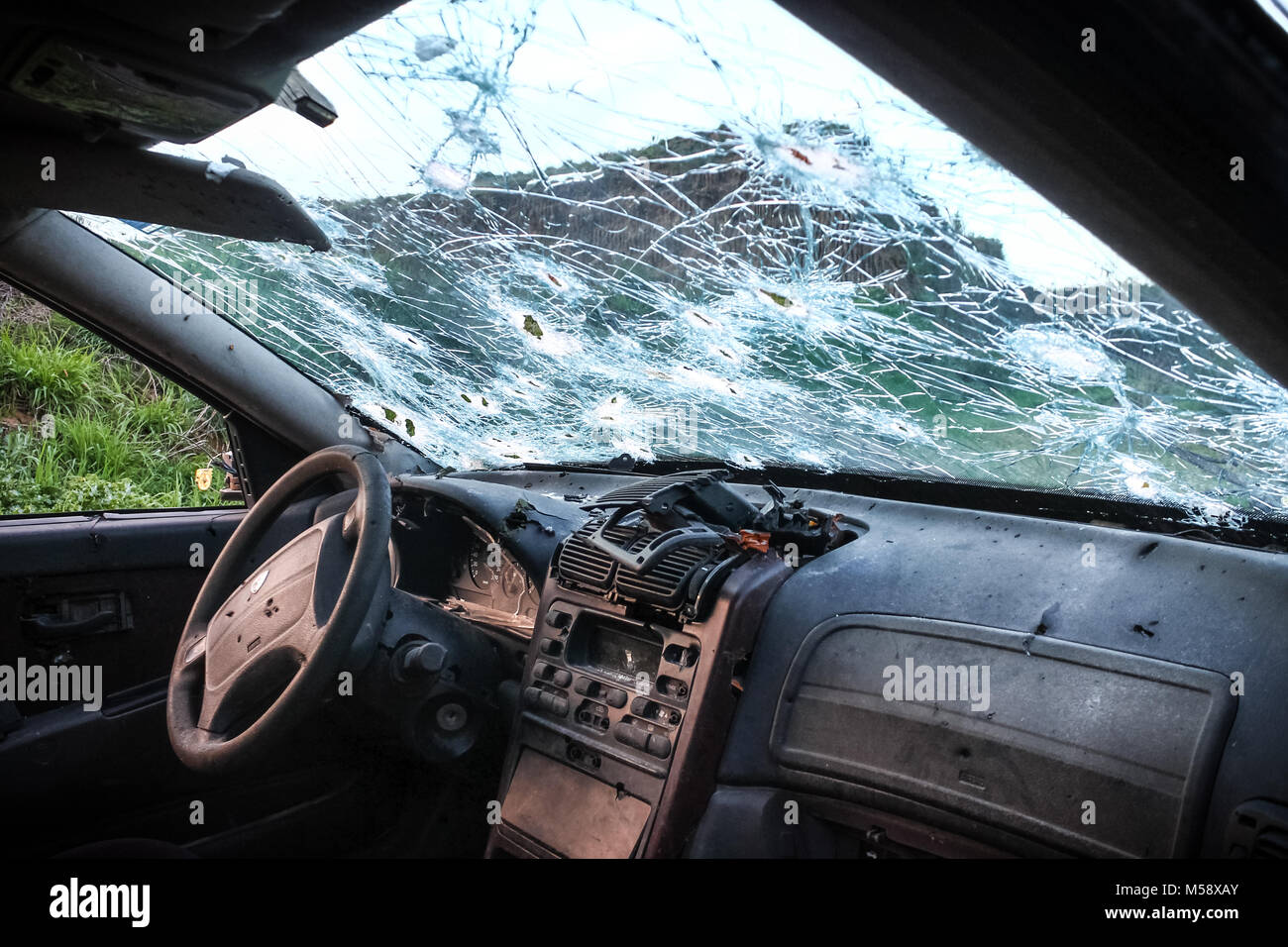 Cracked windshield from gun shots, viewed from inside the car Stock