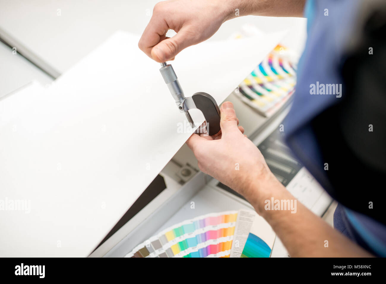 Measuring thickness of the paper sheet with micrometer Stock Photo Alamy