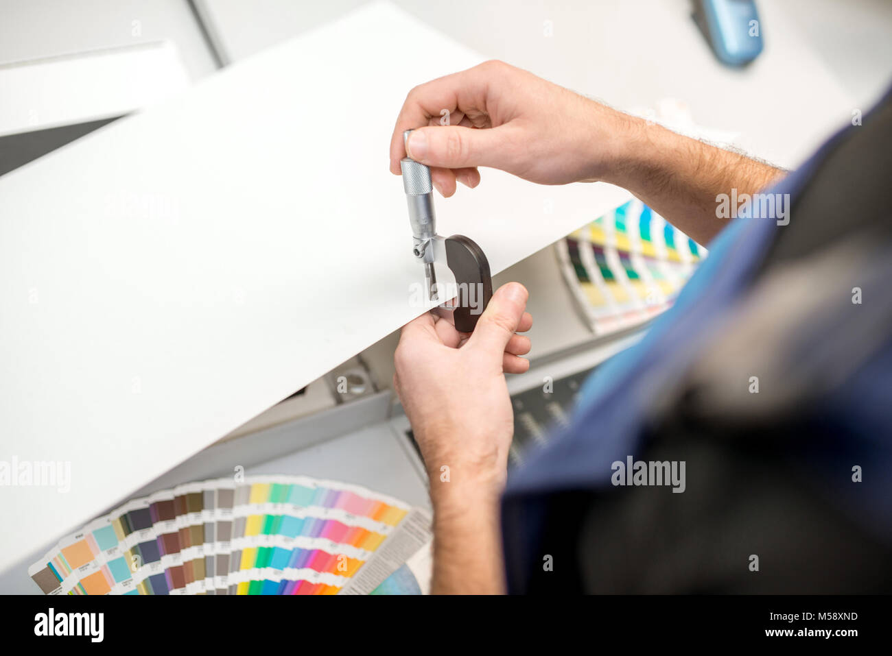 Measuring thickness of the paper sheet with micrometer Stock Photo Alamy