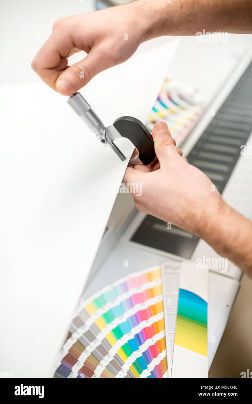 Measuring thickness of the paper sheet with micrometer Stock Photo Alamy