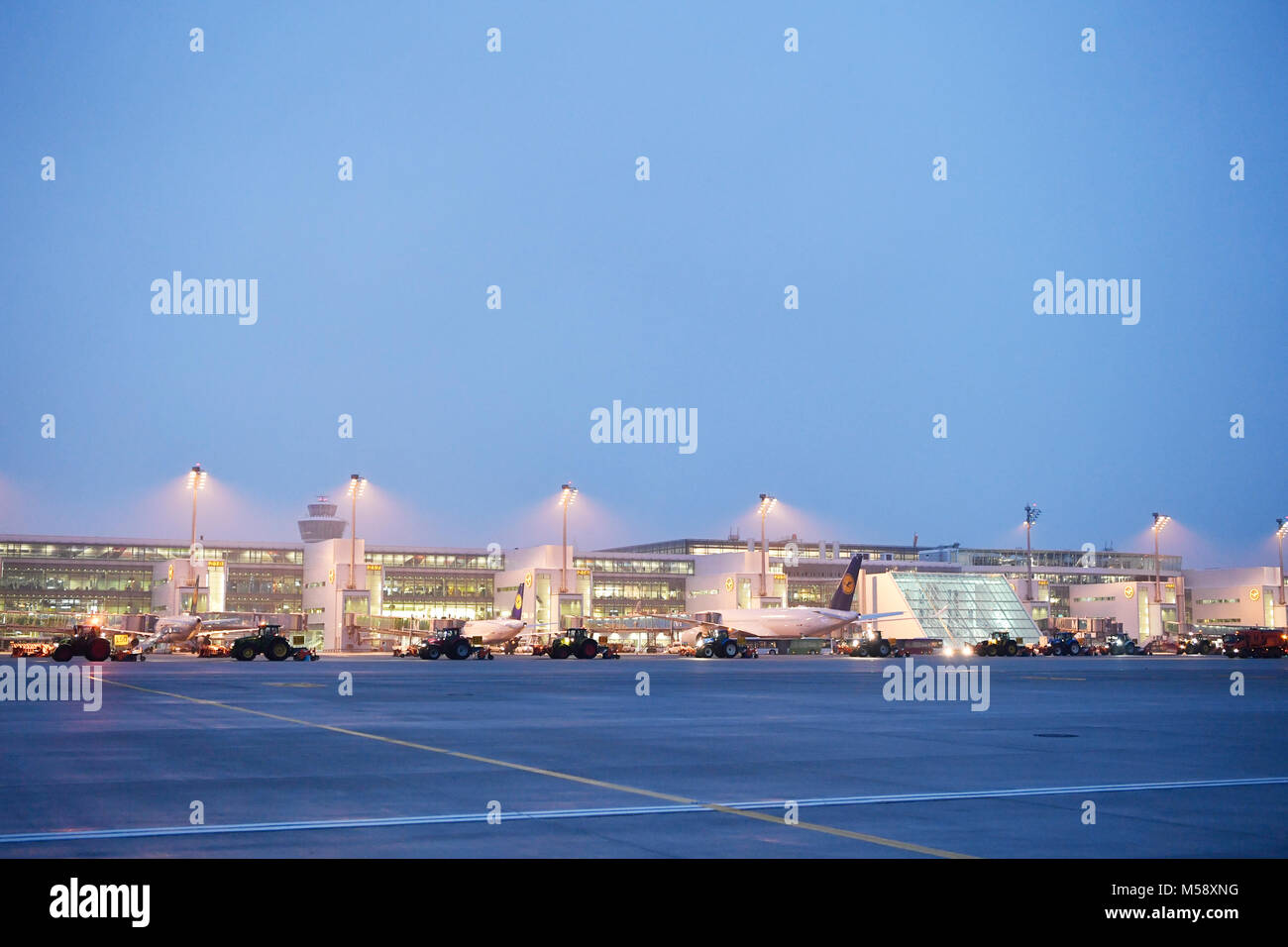 winter, snow, ice, truck, tractor, snow plow, cold, night, blue, Munich, airport, terminal, tower, satellite, terminal 2, muc, Bavaria, Germany Stock Photo