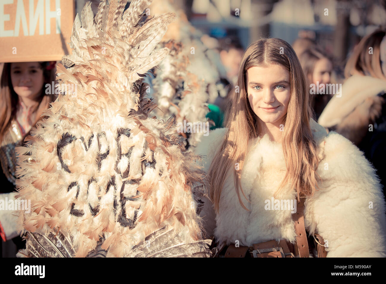 Beautiful Surva Kuker girl smiling in the shadow of her mask Stock Photo