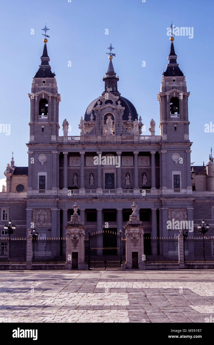 View of La Almudena Santa María's Cathedral in Madrid with Royal Palace of Madrid in Spain Stock Photo