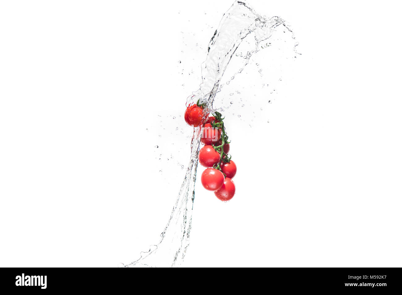 fresh cherry tomatoes in water splashes isolated on white Stock Photo ...