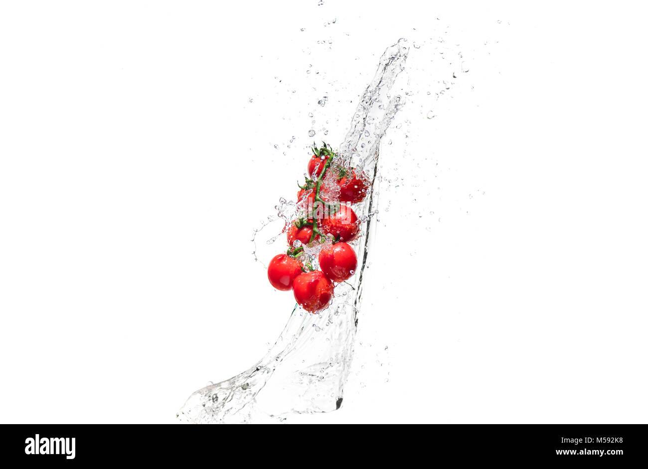 fresh cherry tomatoes in water splashes isolated on white Stock Photo ...