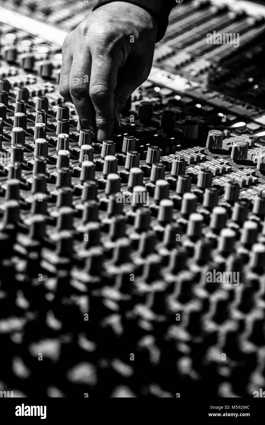 The dj uses a mixing console to manage elettronic music. Stock Photo