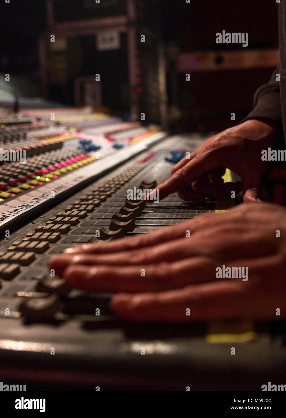 The dj uses a mixing console to manage elettronic music. Stock Photo