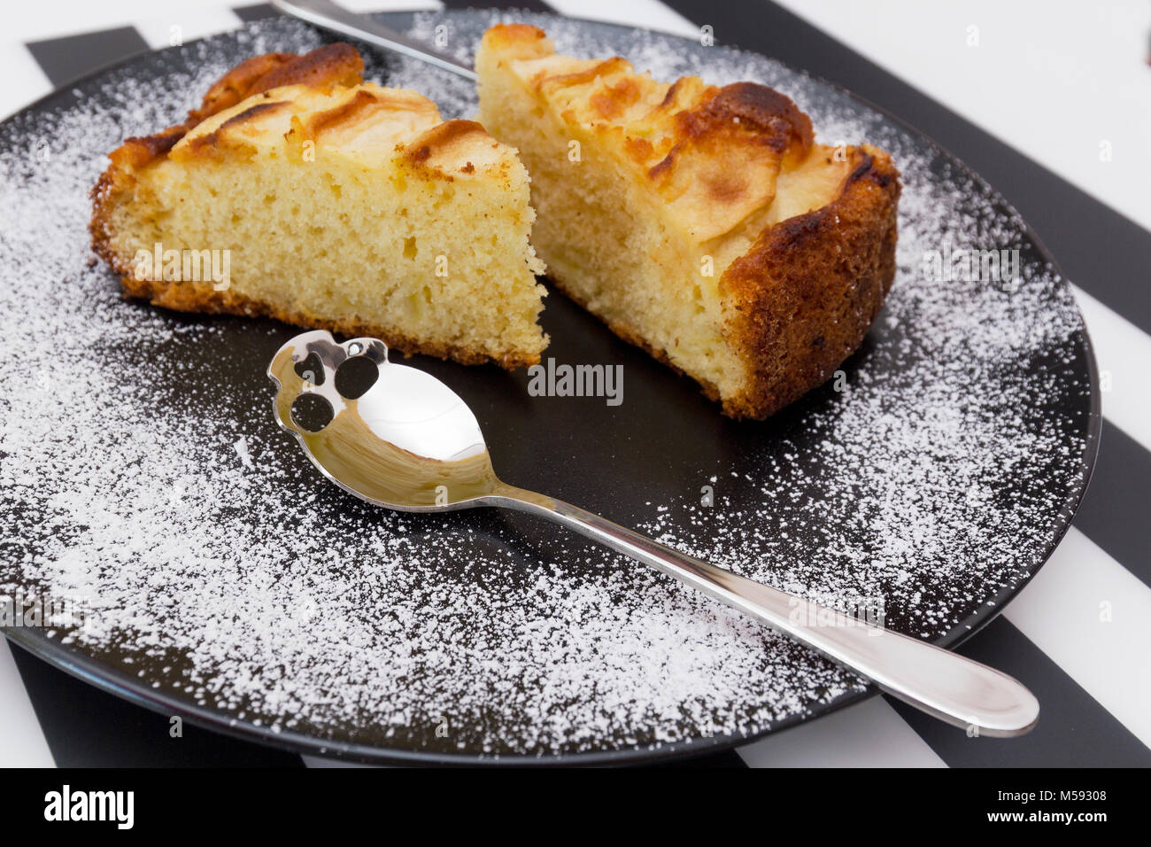 A delicious apple pie ready to be eaten with a spoon shaped skull. Stock Photo