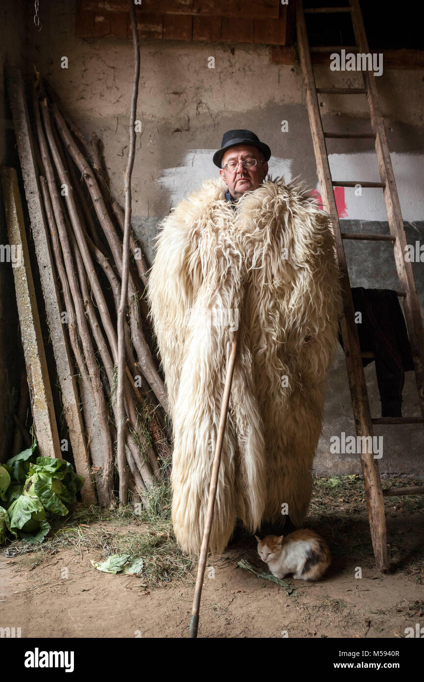 Romanian shepherd wearing a traditional coat made from sheep skins Stock  Photo - Alamy