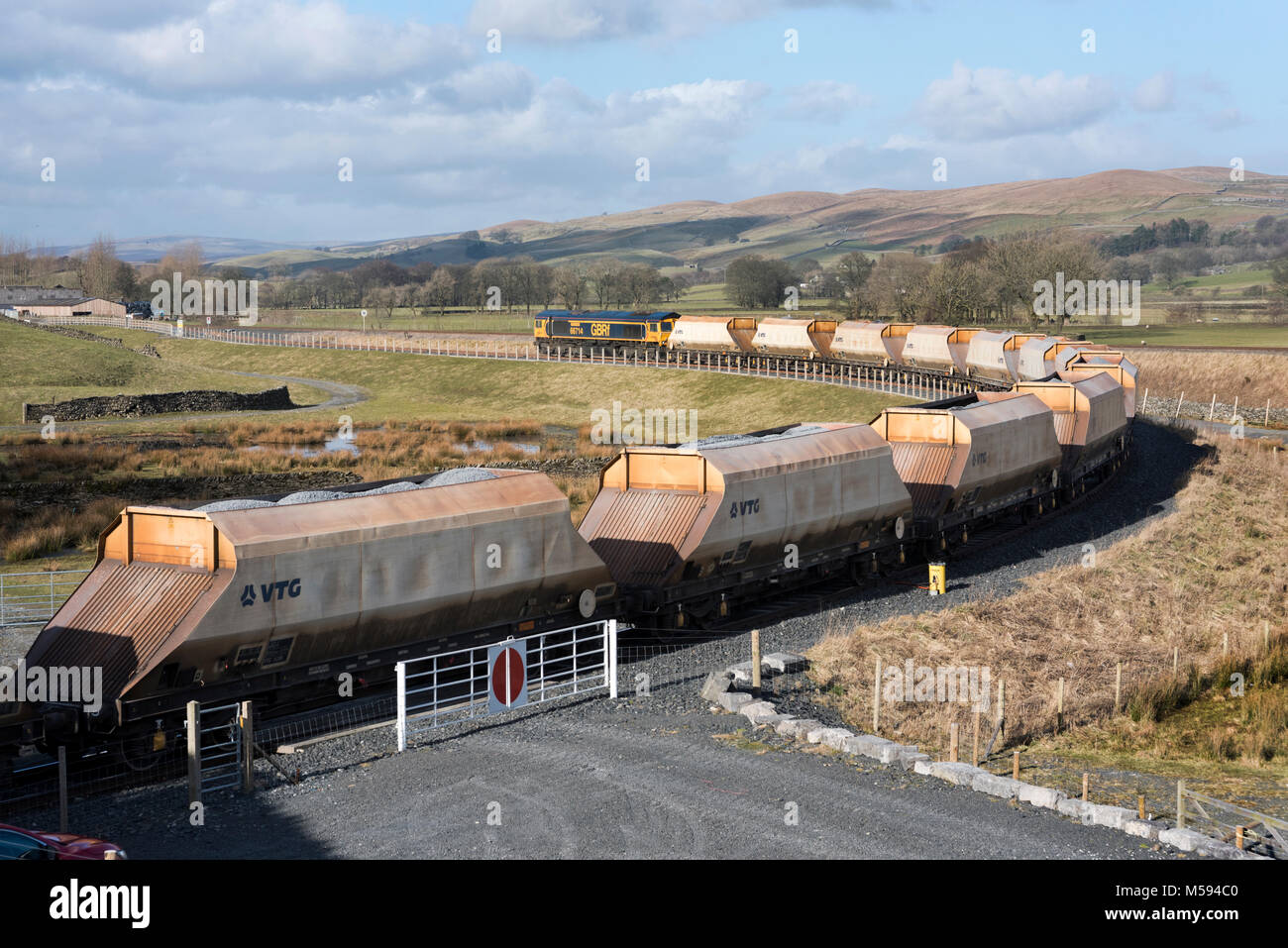 A  train prepares to leave Arcow Quarry siding, Helwith Bridge, North Yorkshire, with a load of crushed stone. Stock Photo