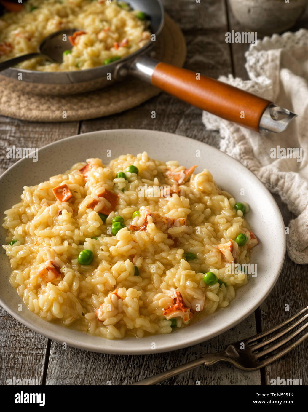 A plate of delicious homemade lobster risotto with green peas. Stock Photo