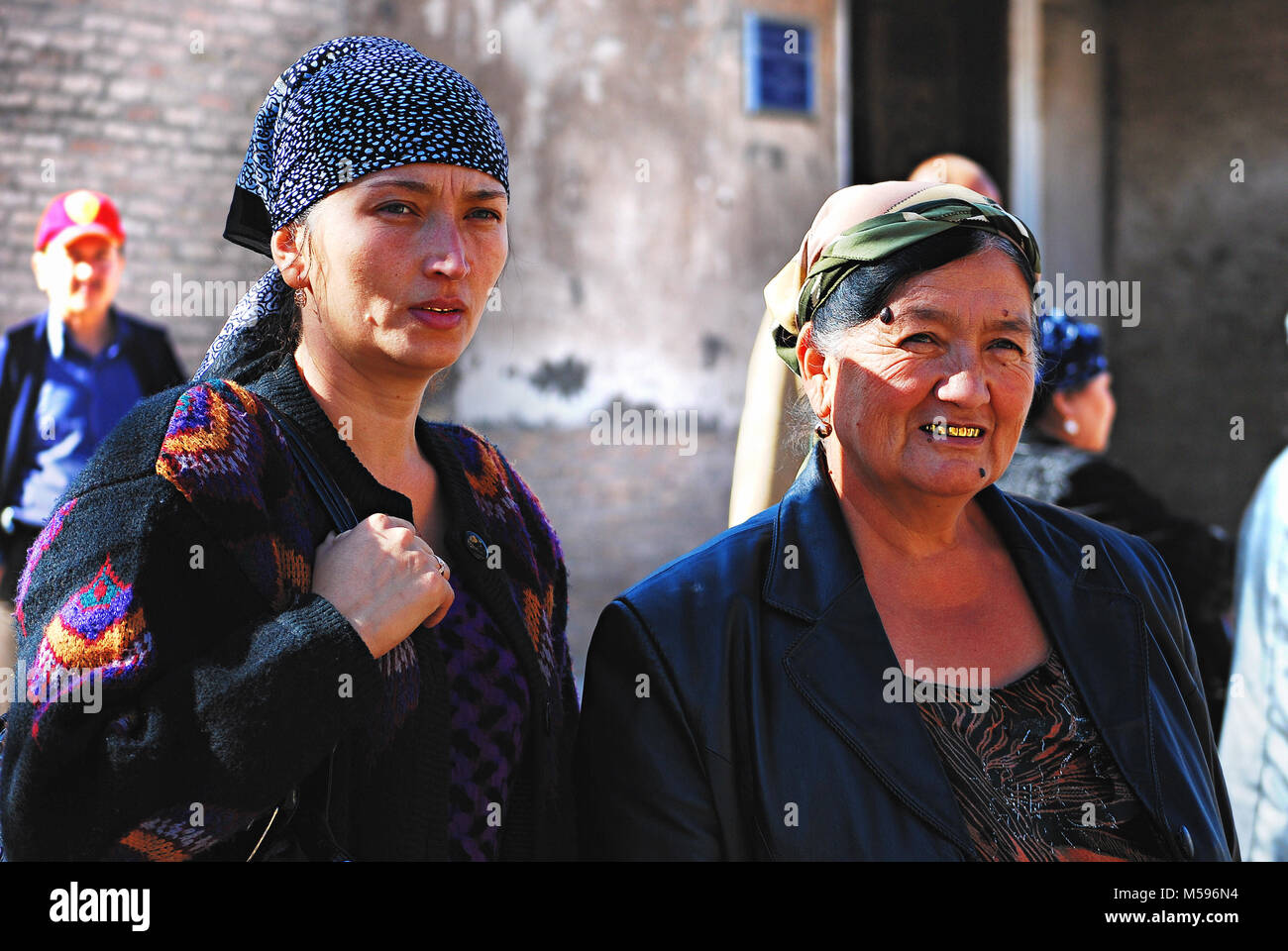 Women with golden teeth walking in the city - Uzbekistan Stock Photo