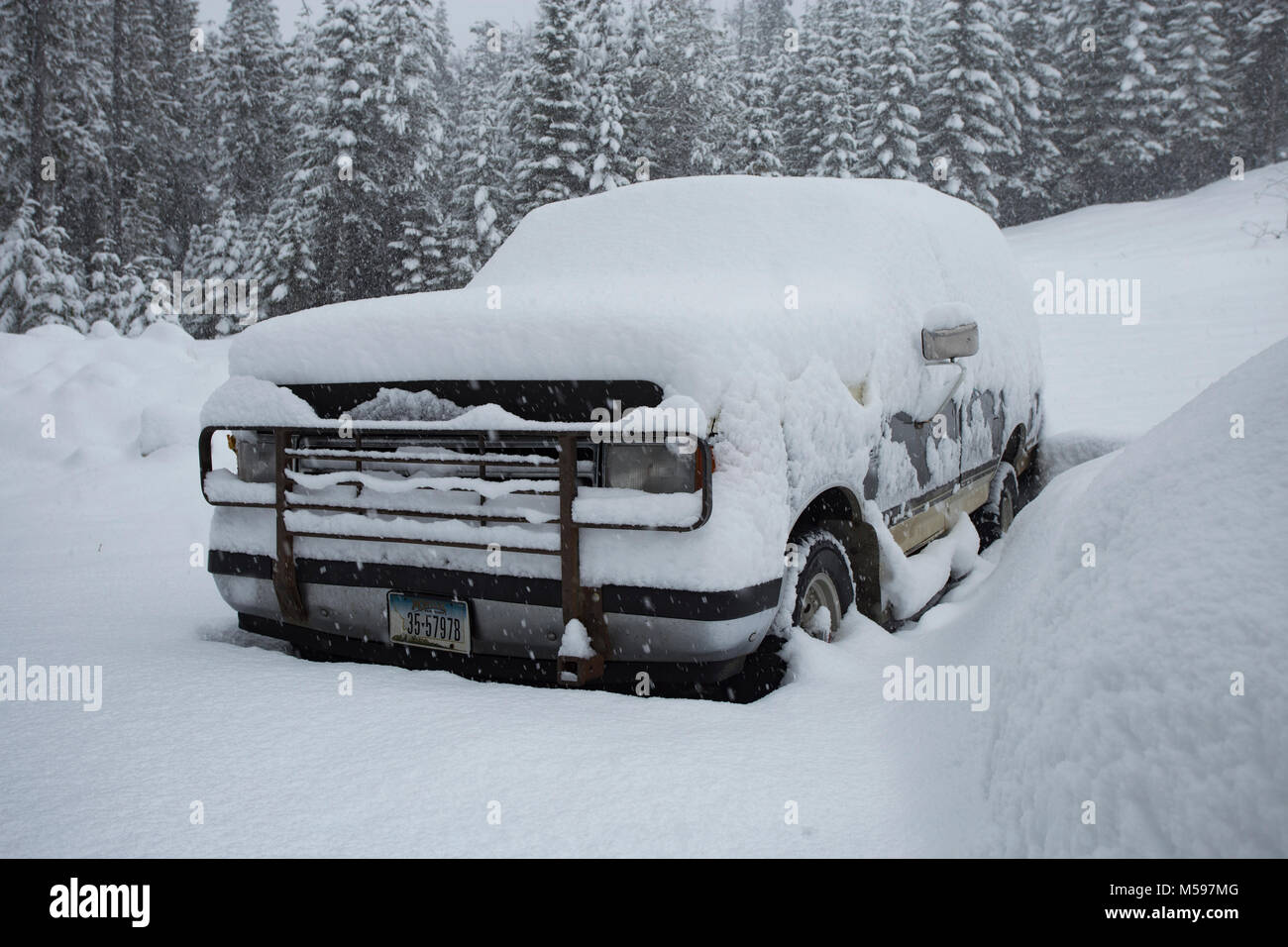 A 1987 Ford F150 pickup truck, on the side of a snow-covered hill, on Eagle View, in Sanders County, Montana Stock Photo
