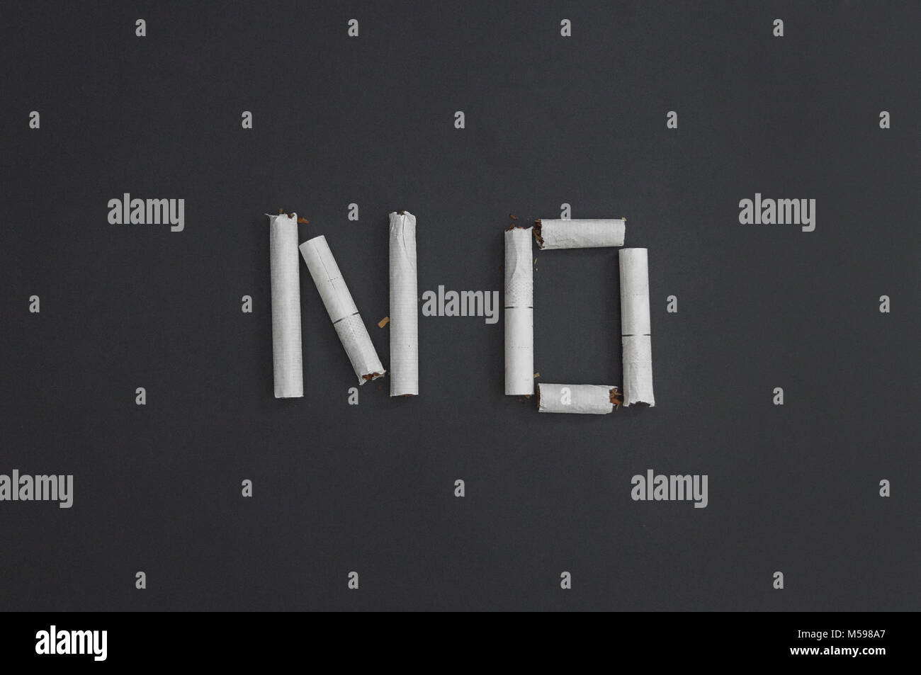 No - an inscription word made from broken cigarettes to visualize the cessation of smoking. Against smoking - against cancer. Stock Photo