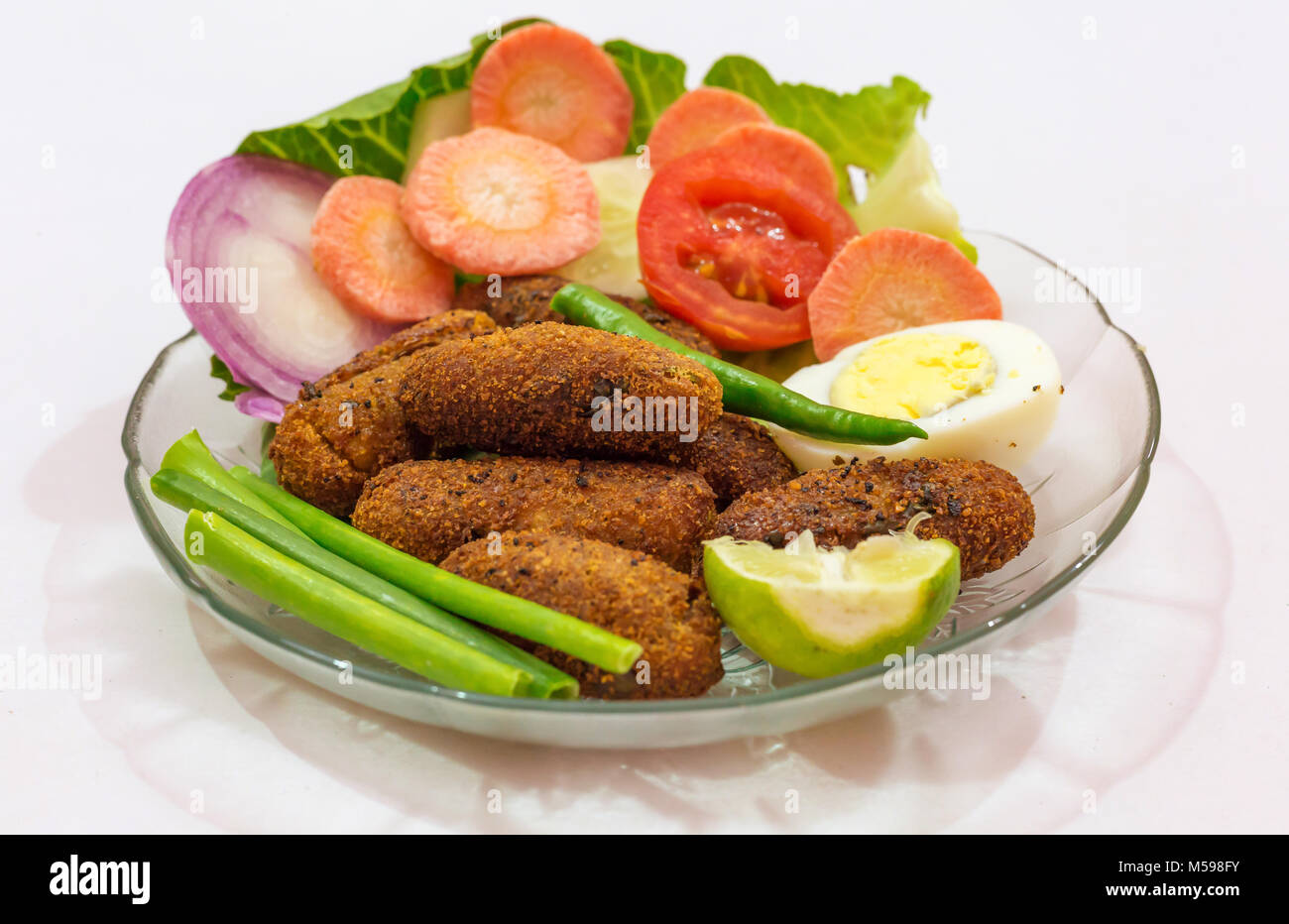 Crispy deep fried fish finger Indian starter dish garnished with beans