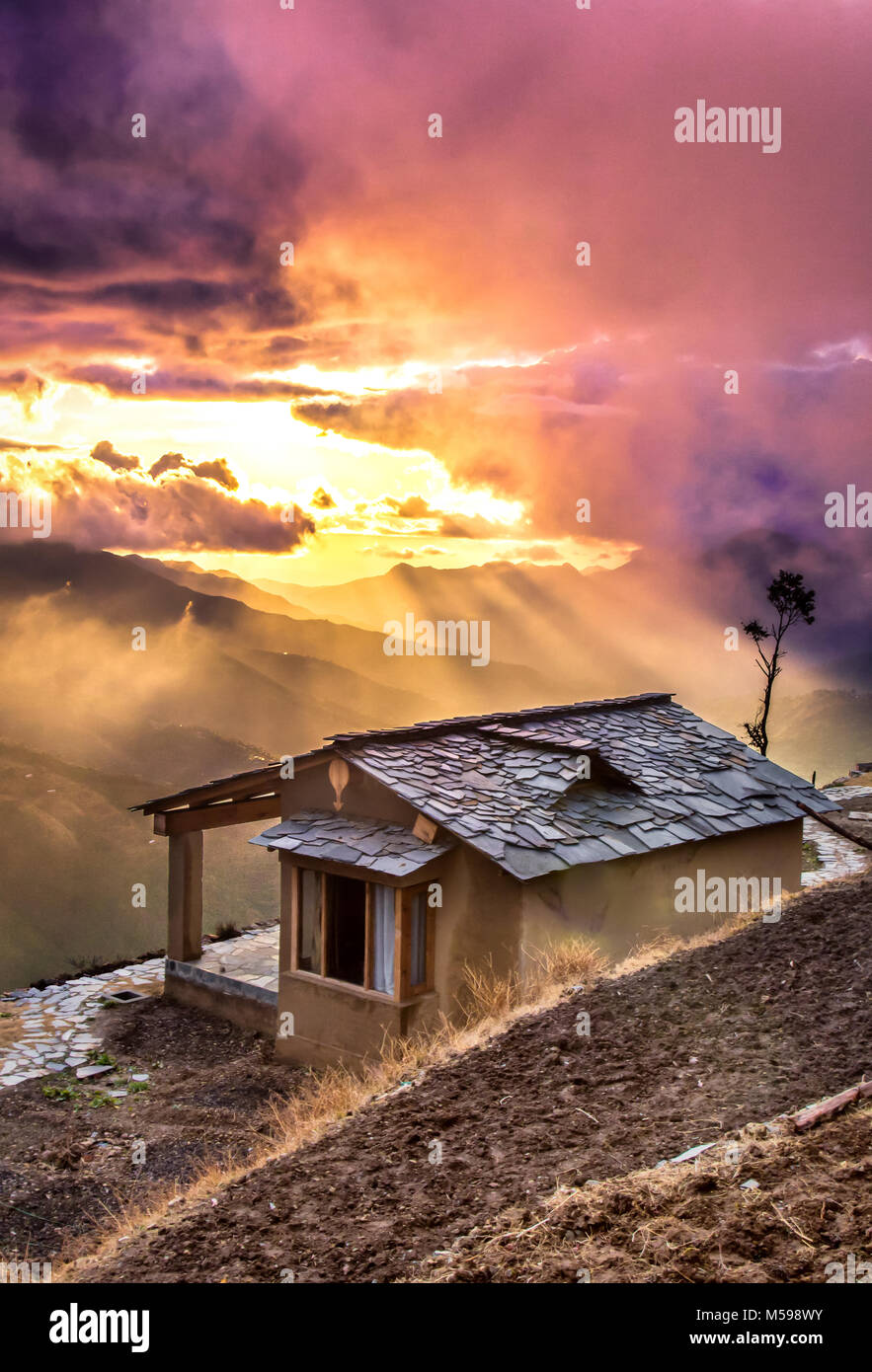 Burst of clouds during sunset on one fine rainy day Stock Photo