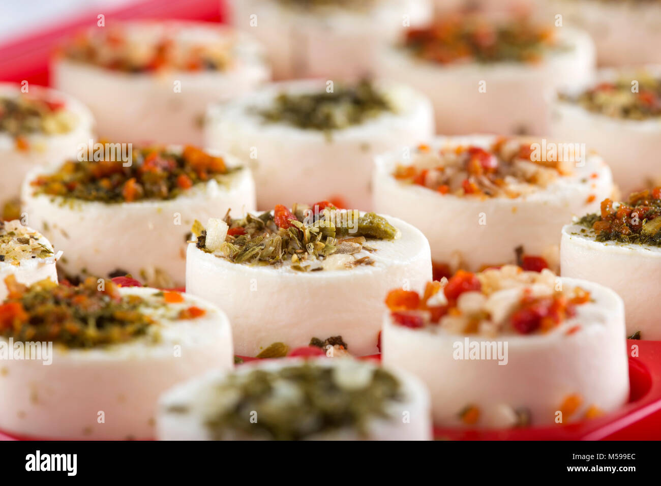 Cheese appetizer with hebs and dried vegetables on top Stock Photo